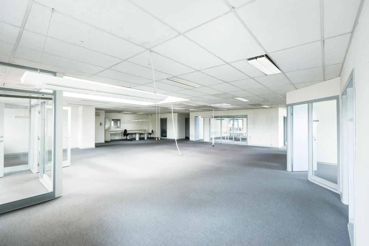 A suspended ceiling in a commercial space, with removable panels for easy access to wiring and ductwork, providing maintenance and accessibility benefits